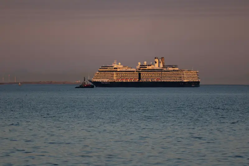A cruise ship on a calm sea at dusk
